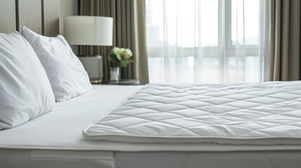 Fototapeta premium Neatly arranged white mattress protector on well-made bed for enhanced search relevance