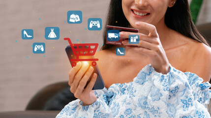 Elegant customer wearing blue dress controlling device choosing online platform. Smart consumer...