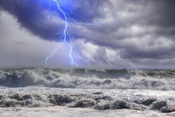 A stormy ocean with large strong waves and lightning