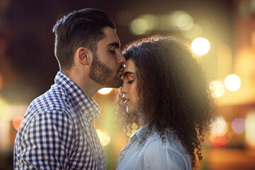 Couple, kiss and night with love in city for affection, date or outdoor romance together. Man,...