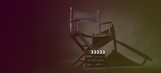 Director chair and Clapper board or slate on black background.