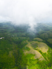 Fototapeta premium Aerial view of tropical savanna Hill at Nusa Penida , Bali Indonesia. Drone shot scenery of valley / hills at Nusa Penida Bali