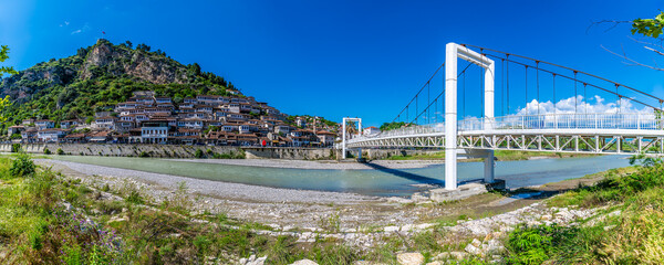 A view along the pedestrian bridge over the River Osum towards the Old Quarter in Berat, Albania in...