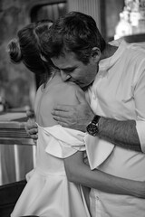 A young couple in wedding looks posing in a stylish loft bar.