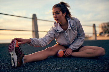 Girl, outdoor and stretching legs on floor, ready and warm up for exercise or fitness training....