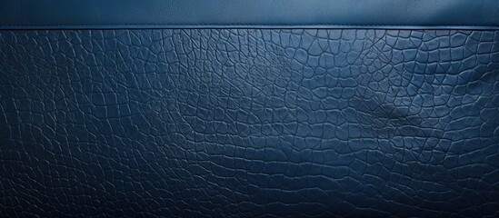 A copy space image featuring a genuine looking synthetic leather background with a rich deep blue hue and textured appearance