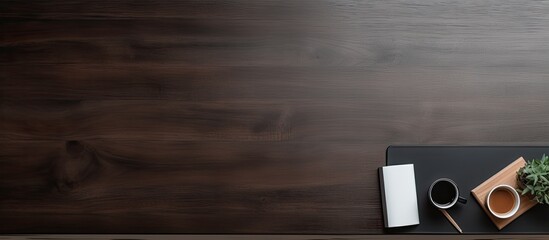 The copy space image shows a sleek and sophisticated workspace from a bird s eye view featuring a black leather desk with a notebook and pen