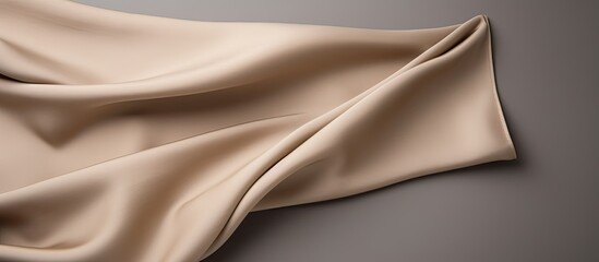 Fototapeta premium Copy space image of a beige cloth napkin displayed against a gray backdrop