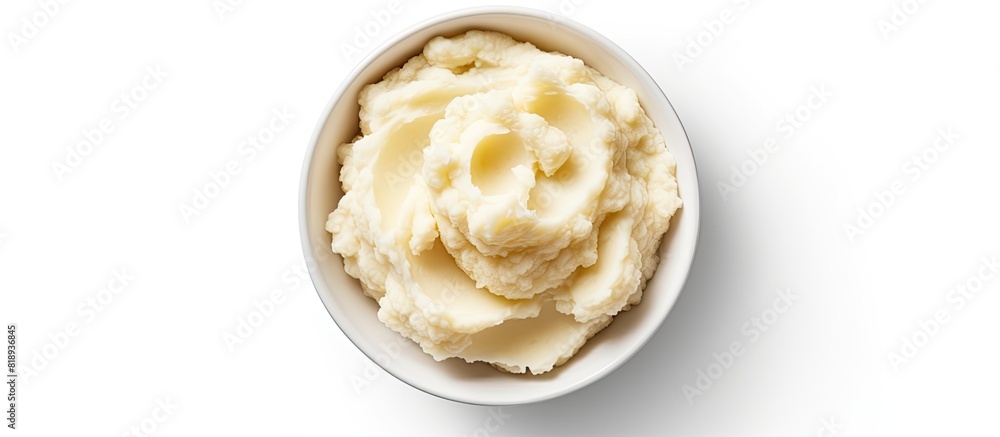 Poster top view of a bowl filled with delicious mashed potatoes providing a white background with enough em