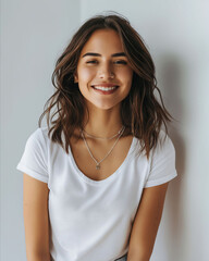 Fototapeta premium A young woman smiling in a white shirt.
