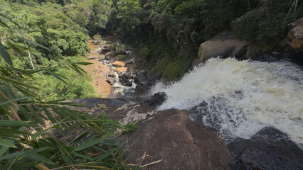 Slow Motion Waterfall in Lush Jungle with People Bathing