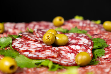 Thinly sliced smoked salami sausage with cilantro and olives
