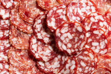 Thin slices of smoked sausage close-up.