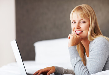 Portrait, happy and woman with laptop for reading, relax and social media for networking in home....