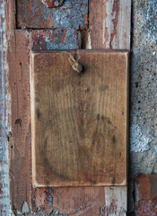 Old wooden blank signboard on the aged cement wall background