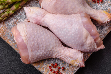 Raw chicken legs with salt, spices and herbs