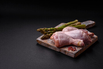 Raw chicken legs with salt, spices and herbs