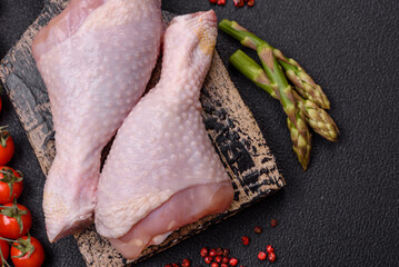 Raw chicken legs with salt, spices and herbs