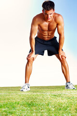 Man, exercise and tired rest for running workout or blue sky nature for training wellness, cardio or grass field. Male person, relaxing and exhausted for fitness sport or marathon, health or fatigue