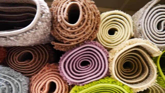 Close-up of many colored rolled carpets