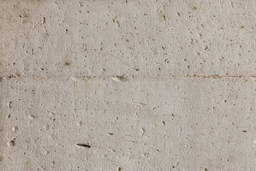 A white stone wall with porous surface. Vector white stone texture background