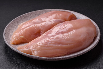 Raw chicken fillet with salt, spices and herbs