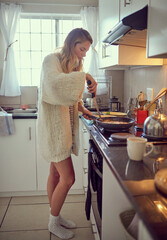 Girl, morning and cooking breakfast in kitchen for daily routine for healthy eating or living with...