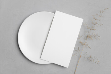 Wedding paper menu card mockup with white plate and dry grass decoration, blank mockup with copy...