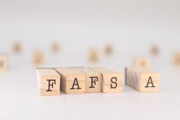 FAFSA acronym. Concept Free application for federal student aid written on cubes isolated on white.