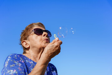 elderly woman having fun outdoors in summer holidays. Freedom in the elderly