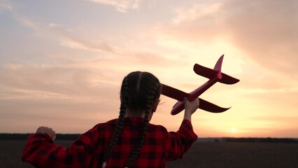child kid girl with toy pilot runs into sunset dream flying flight, kid's adventure, child in...
