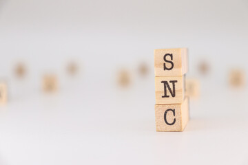 SNC letter written on wooden cubes isolated on white background.