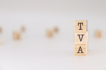 TVA acronym. Concept of Value Added Tax written on wooden cubes isolated on white background.