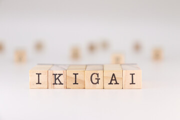 IKIGAI word. Concept of a reason for being represented on wooden cubes isolated on white background.