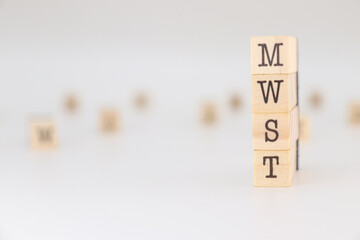 Acornym MWST written on wooden cubes isolated on white background.
