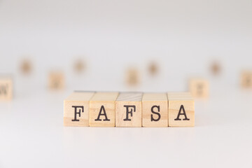 FAFSA acronym. Concept Free application for federal student aid written on cubes isolated on white.