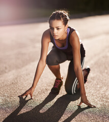 Woman, road and start position for race, marathon and ready for training and exercise. Sprint,...