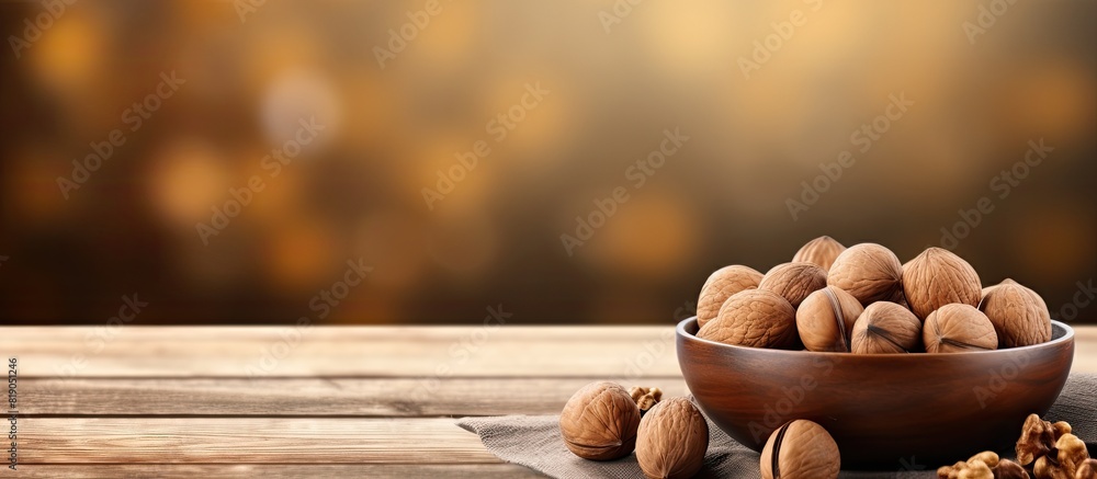 Poster macadamia nuts in the craft package and peeled walnuts in the brown bowl on wooden table close up. c