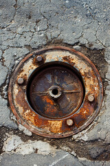 Closeup hatch of the city sewerage. A metal manhole in the city street.