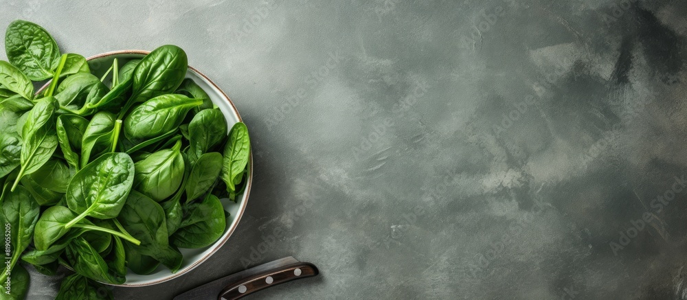 Poster Scissors and a bowl with fresh spinach leaves on textured paper background with text space Healthy food concept. copy space available