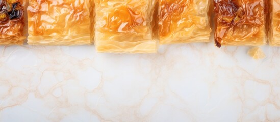 A selection of Baklava on a marble surface viewed from above with space available for additional elements in the image