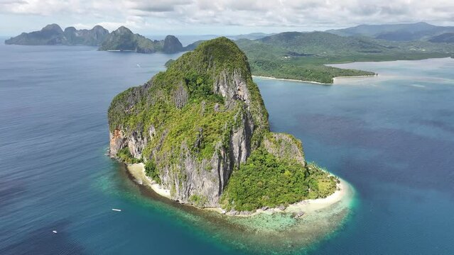 Top shot over Pinagbuyutan island, amazing nature, rocky landscape, pristine beach and blue sea of El Nido, Bacuit bay, Palawan, Philippines 4K