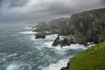 Rocky Cliff Overlooking Large Body of Water