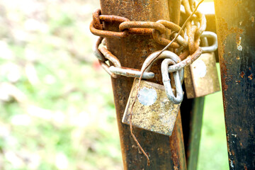 old and rusty lock on metal gate