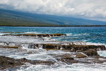 Waves Washing Over The Volcanic Shoreline of Alahaka Bay at Puuhonua o Honaunau National Historic...