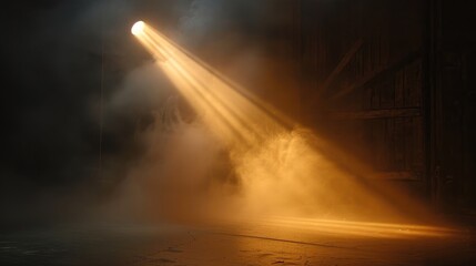 A spotlight shines through the smoke on a stage.