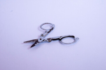 small metal scissors with white isolated object.