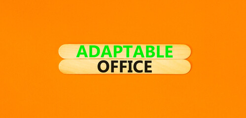 Adaptable office symbol. Concept words Adaptable office on beautiful wooden stick. Beautiful orange paper background. Business Adaptable office concept. Copy space.