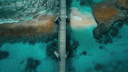 An aerial view of a tropical island showcasing a dock extending into the aqua water leading to a...