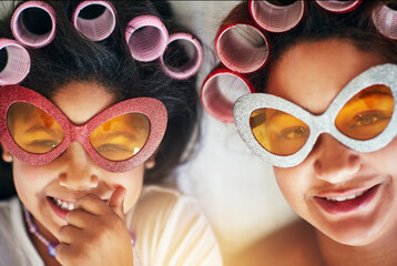 Mother, girl and portrait on bed with rollers for love, fun and hair care together at home. Woman,...